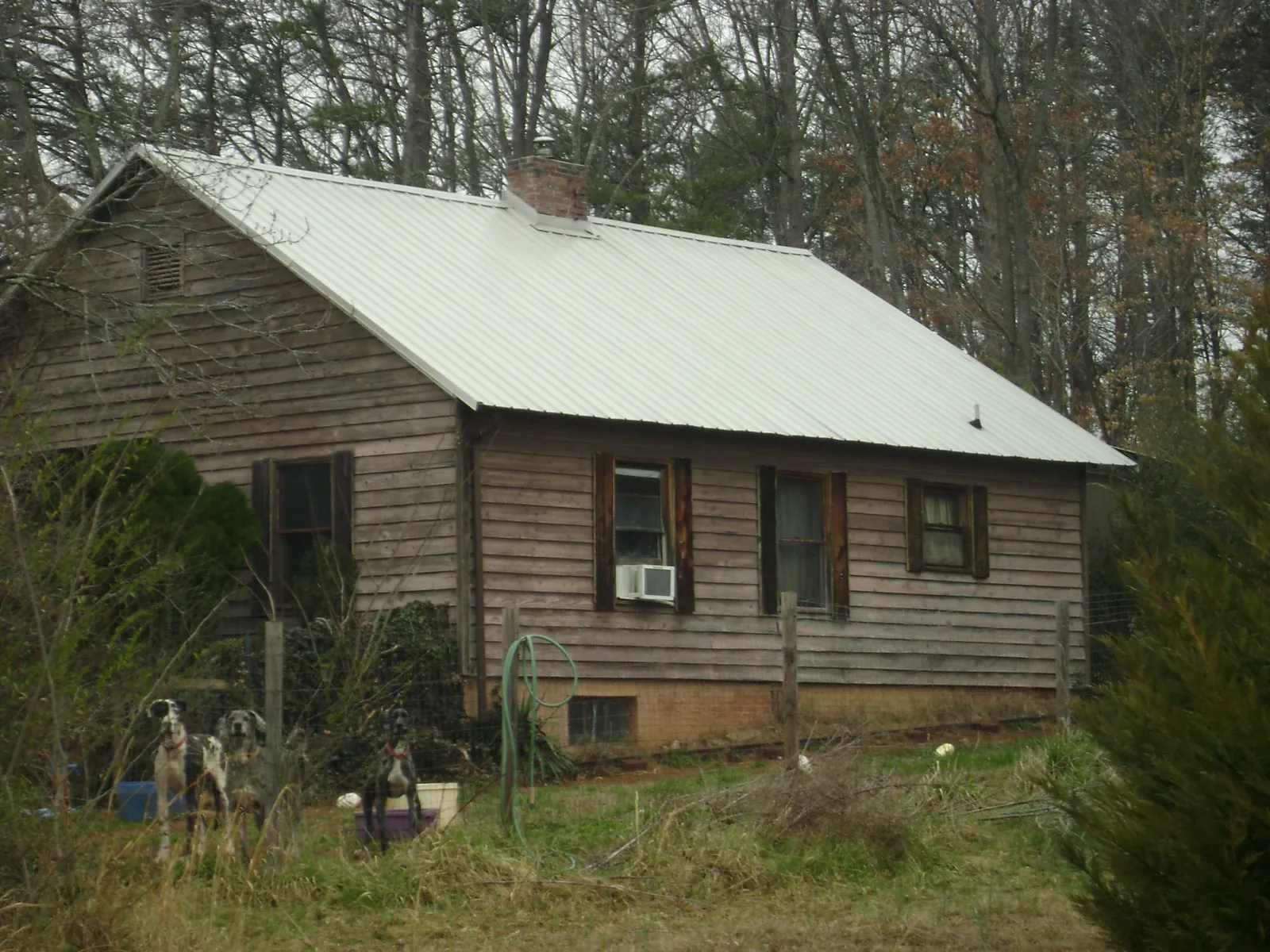 White metal roof on an old wood sided farmhouse, from a Metal Roof Installation job in Burbank